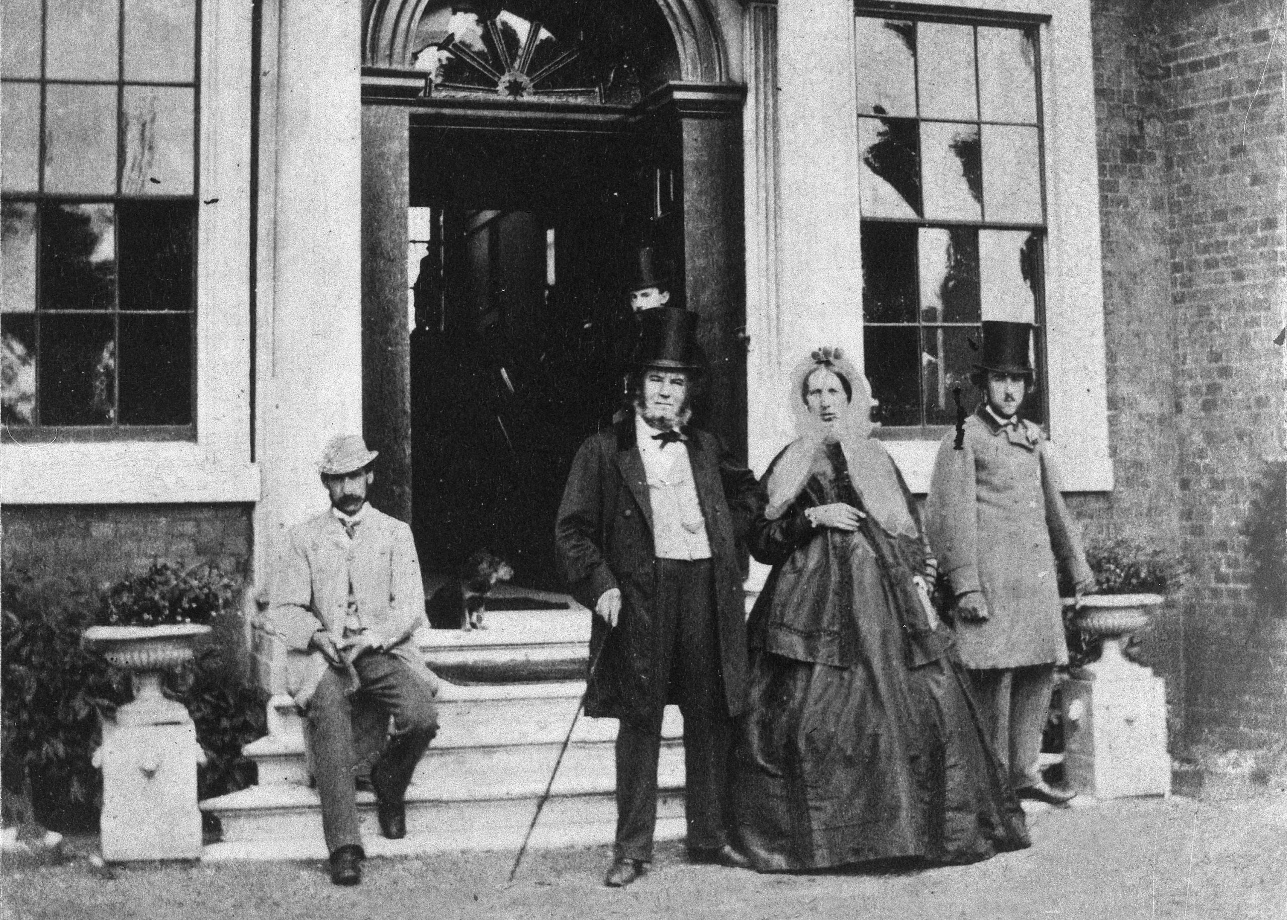 Image of the Lloyd Family outside the steps of their home, now William Morris Gallery. In black and white.