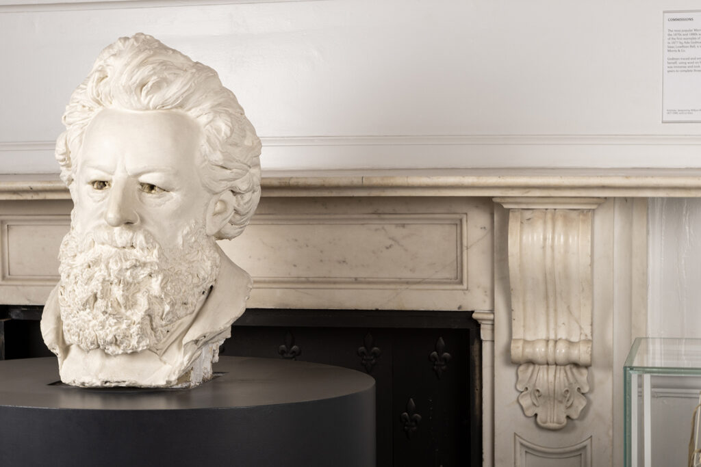 A white bust of William Morris' head