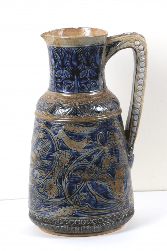 Jug decorated in a pattern of flowers and squirrels in blue and fawn