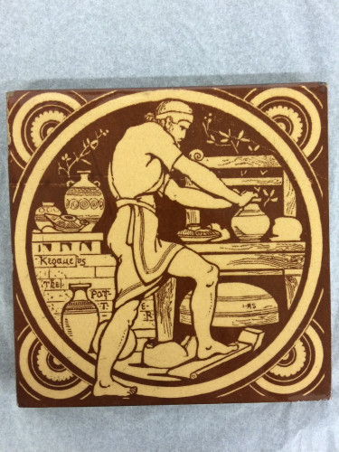 yellow and brown tile showing man making a pot