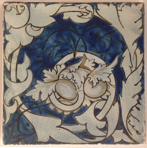 Hand painted tile with scrolling leaves