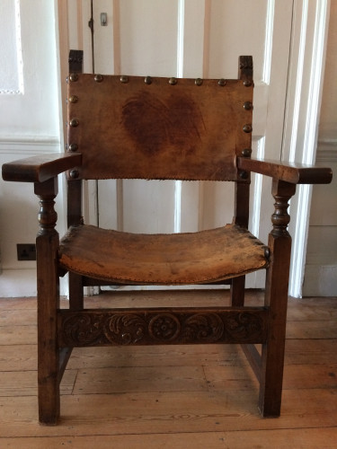Large wooden armchair with leather seat