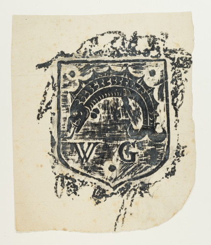 Brass rubbing of a shield design with a fish and the initials "W.G."