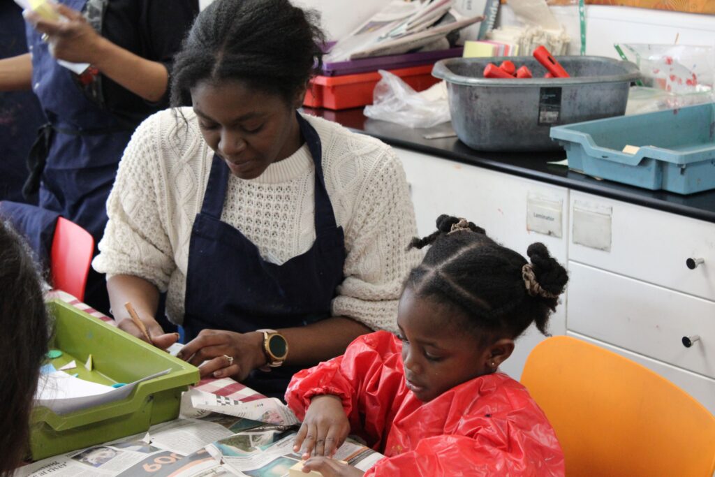 Adult and child participating in craft activities.