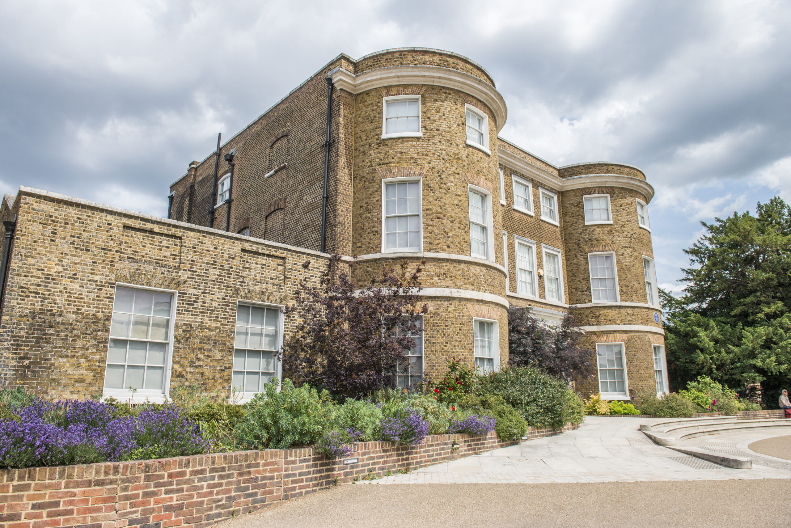 The front of William Morris Gallery, showing planted flower beds to the side of the building