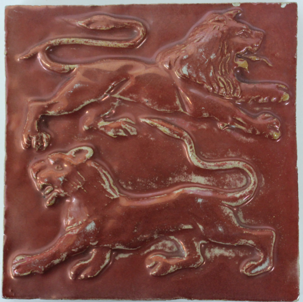 Red lustre tile with two lions