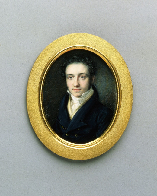 An oval painted portrait of a young man in a gold frame